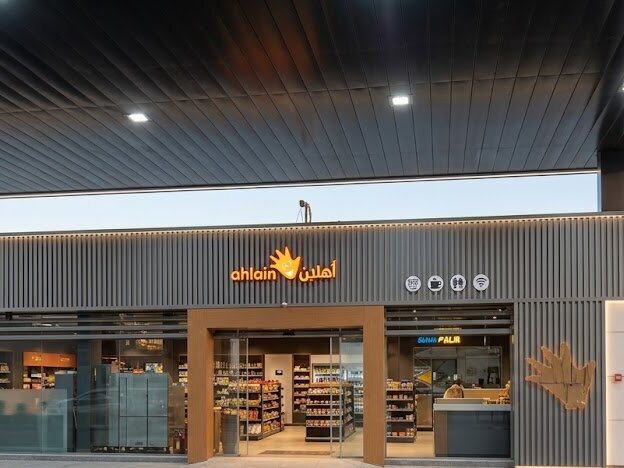 Ahlain branded signage along the canopy facade of a filling station forecourt