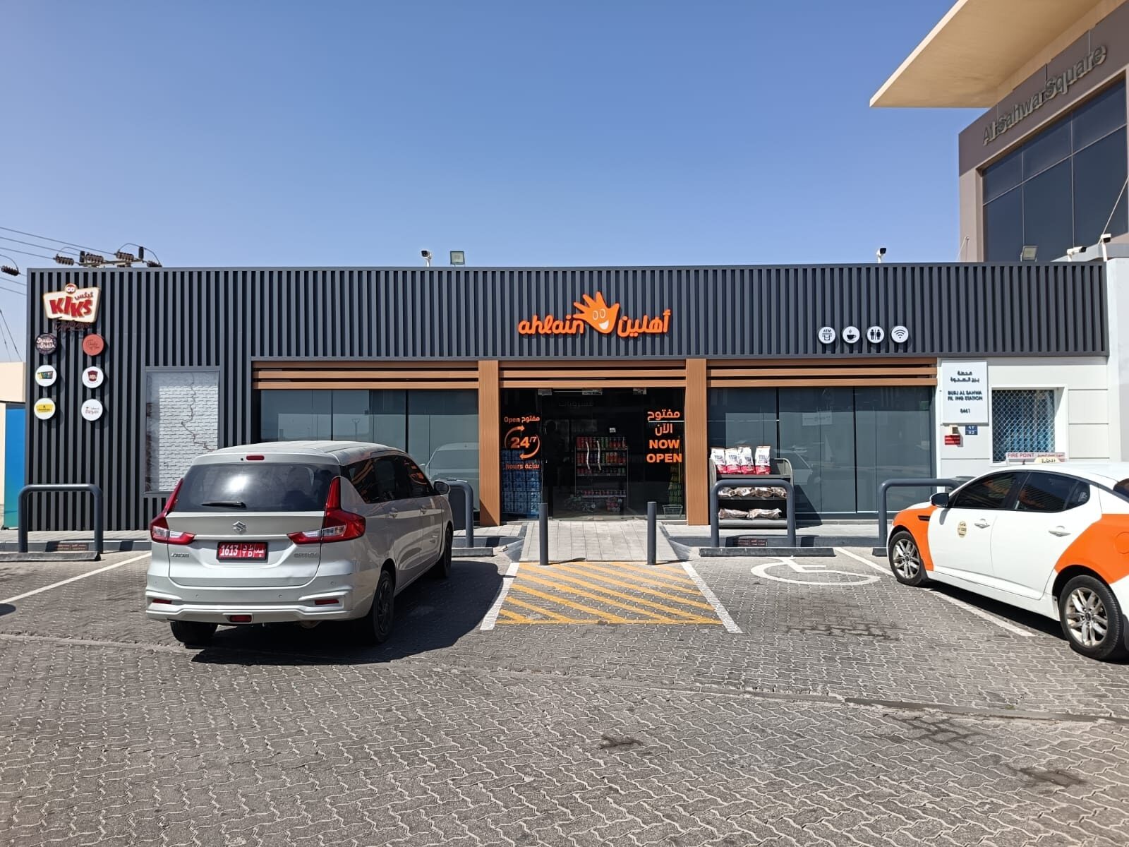 Ahlain convenience store facade with illuminated fascia signage